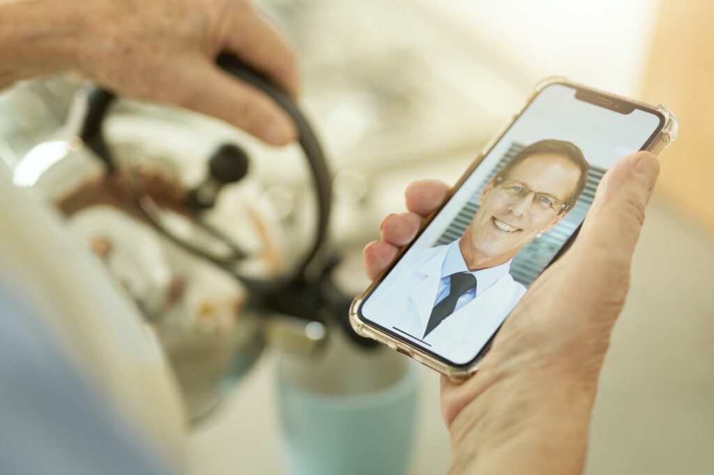 Man contacting his medical doctor on the video-call